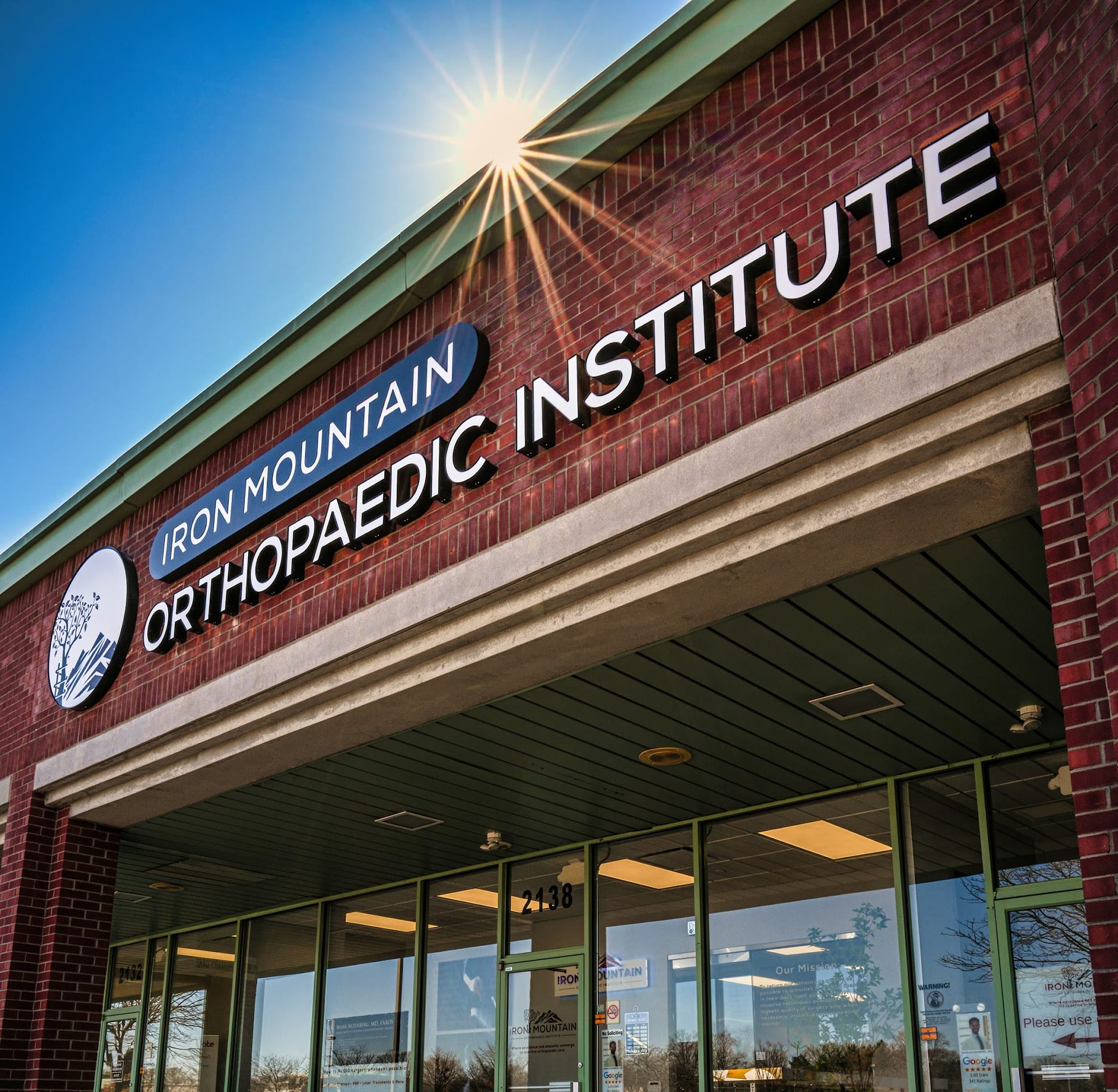 Exterior of Iron Mountain Orthopaedic Institute brick building entrance at 2138