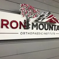 Iron Mountain Orthopaedic Institute lobby sign with tree logo