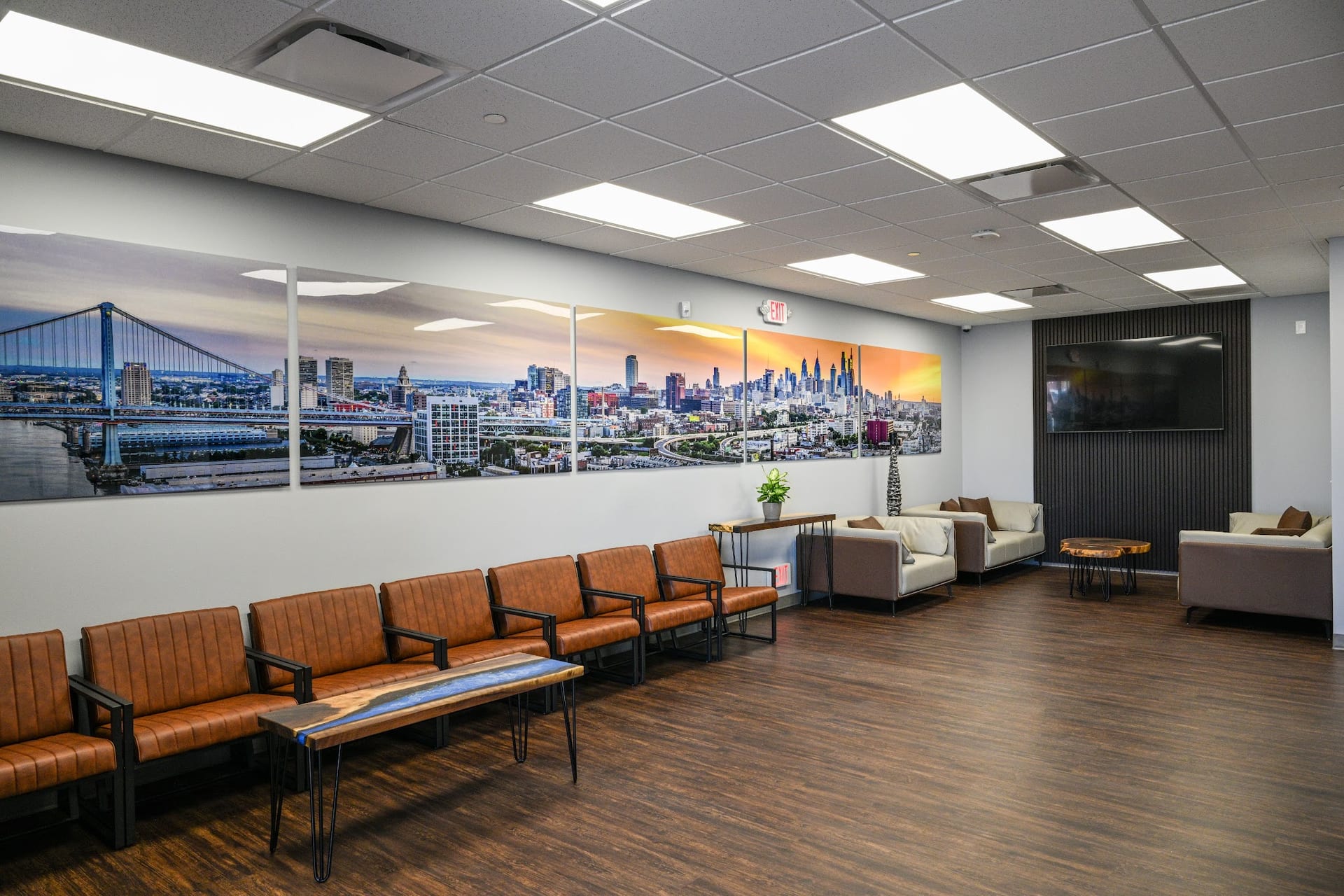 Modern medical office waiting room with leather chairs and Philadelphia skyline artwork