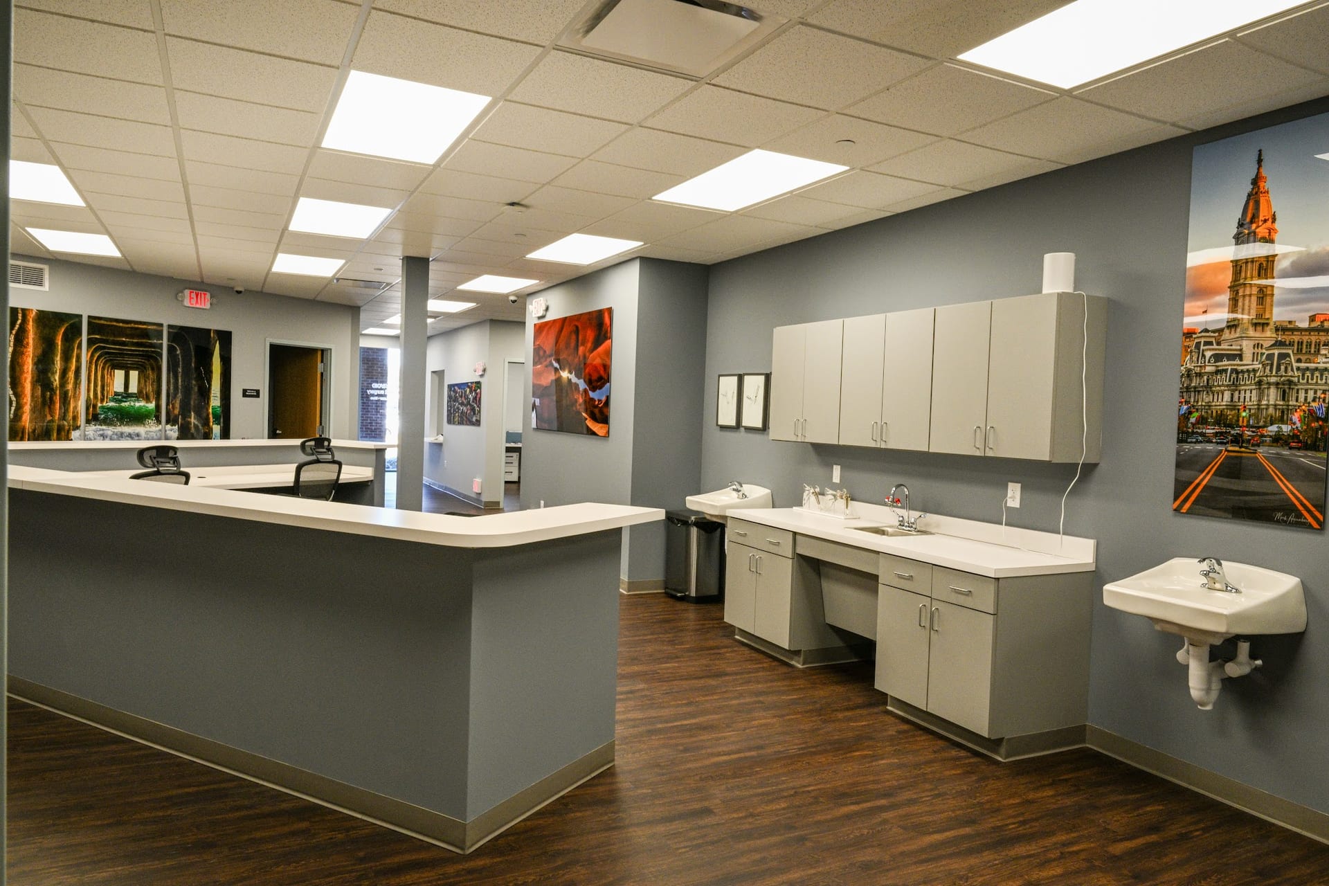 Modern medical office reception desk with multiple sinks and gray cabinetry