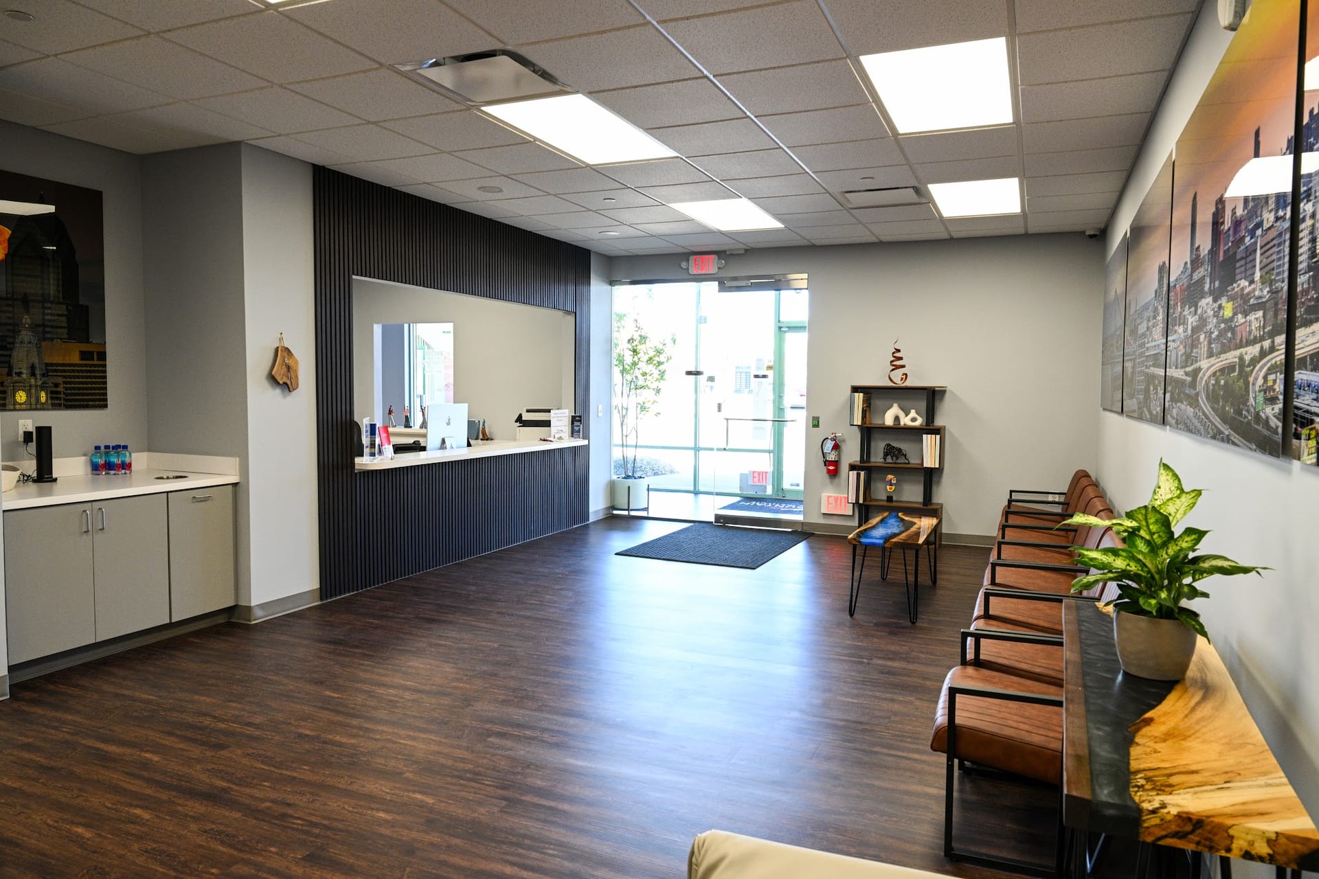 Modern medical office waiting room with wood floors and reception desk