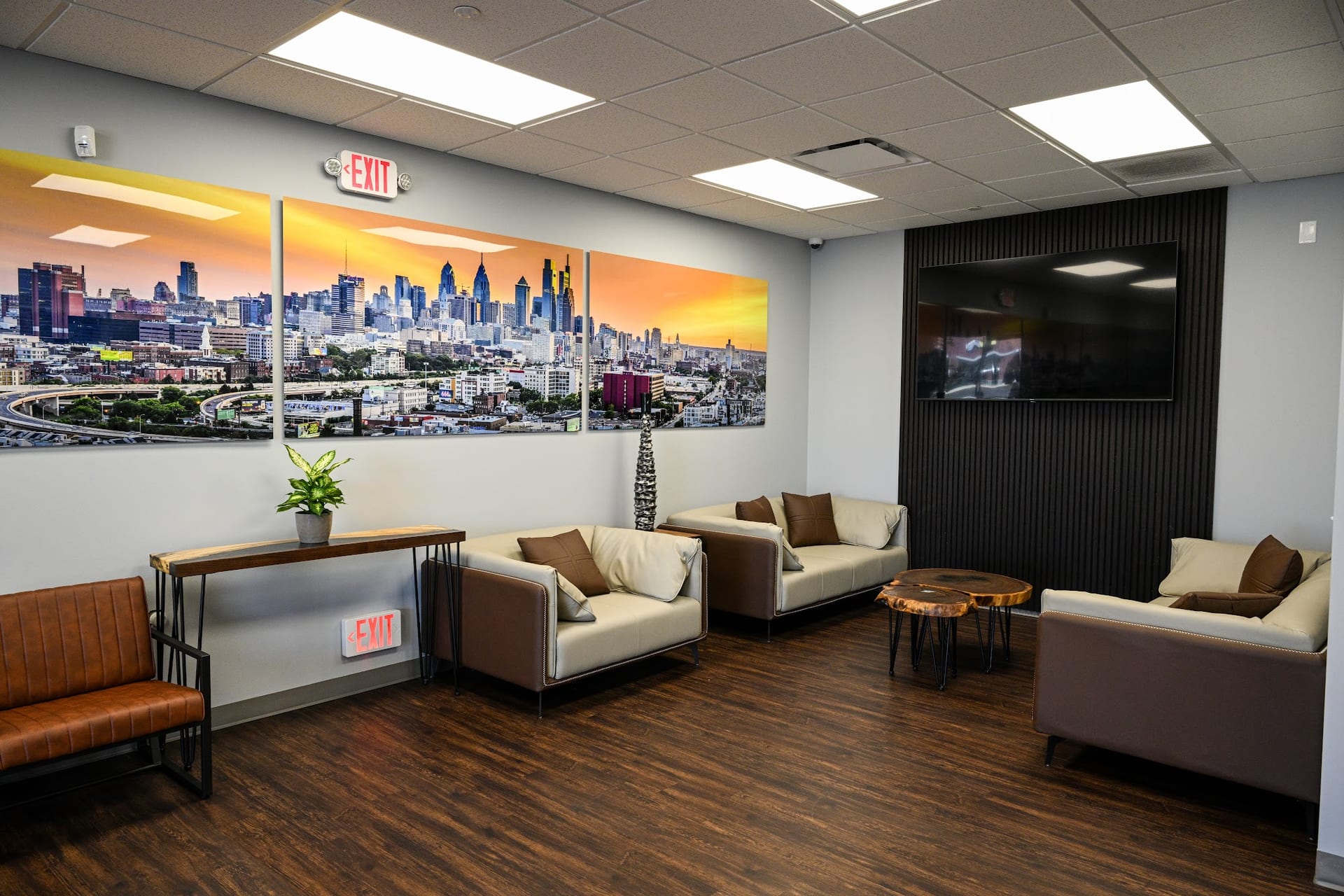 Modern orthopedic office waiting room with cream sofas and Philadelphia skyline artwork